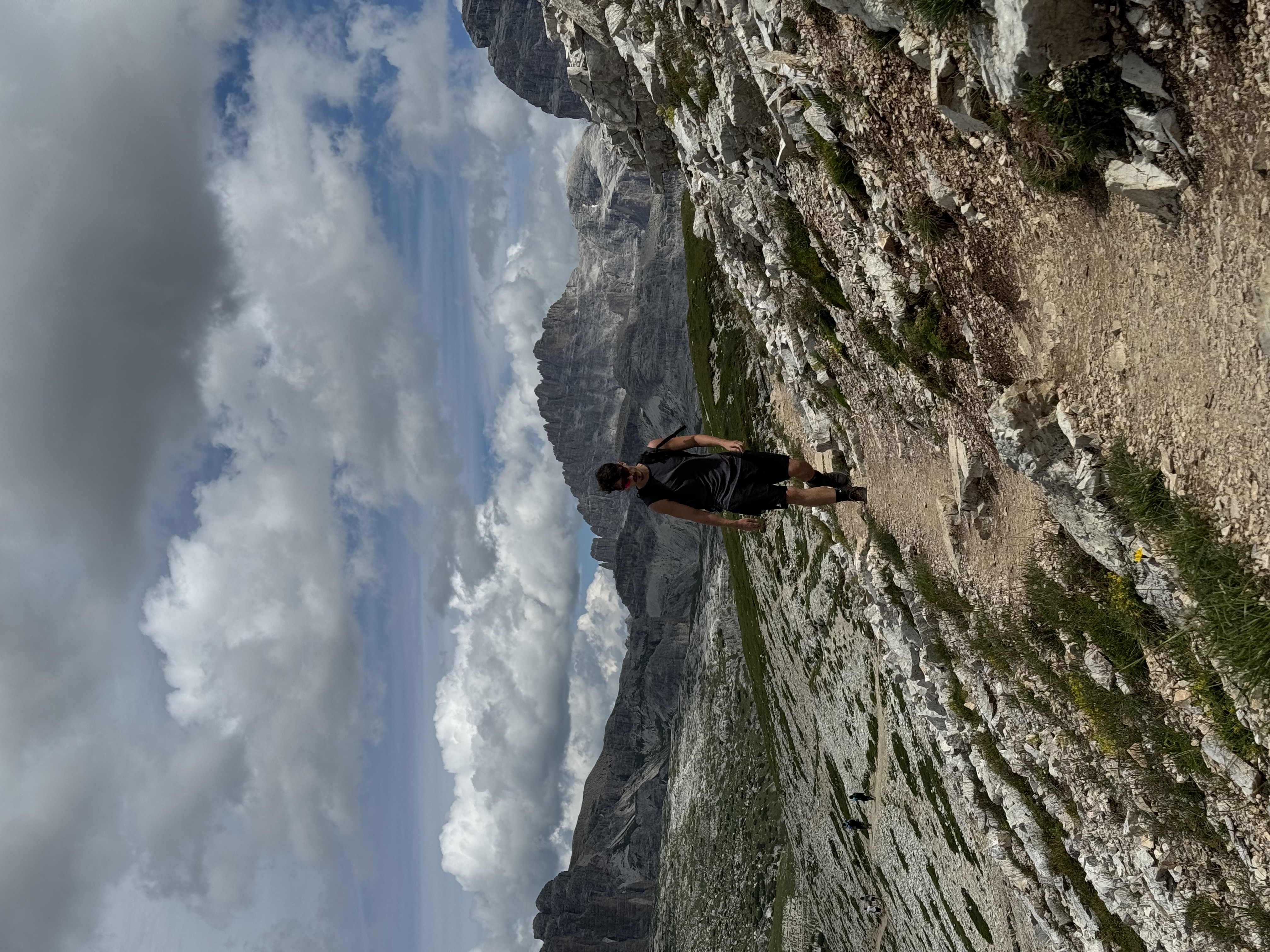 George hiking through a rocky mountain landscape in the Dolomites